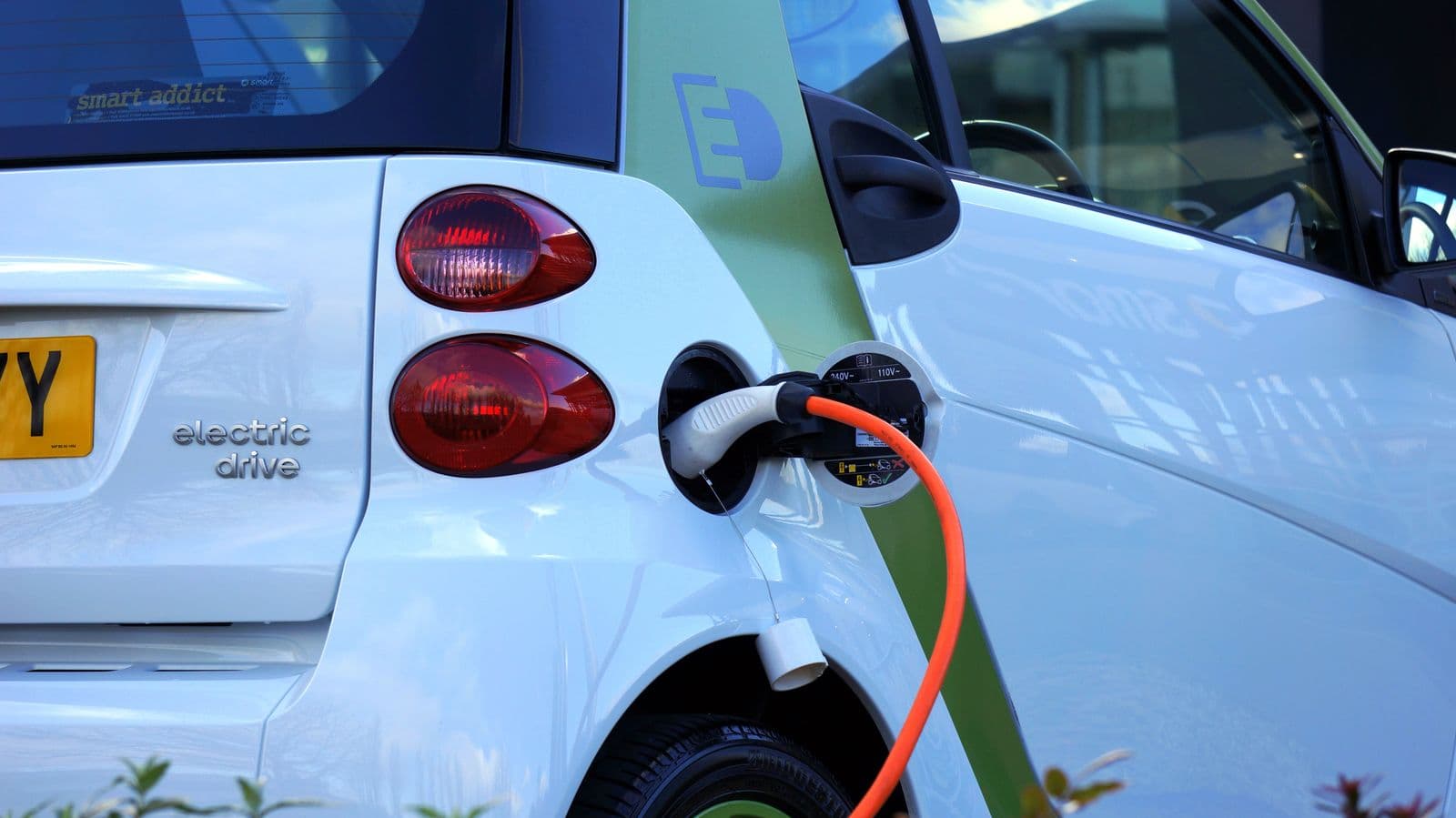 Electric vehicle plugged into a charging station