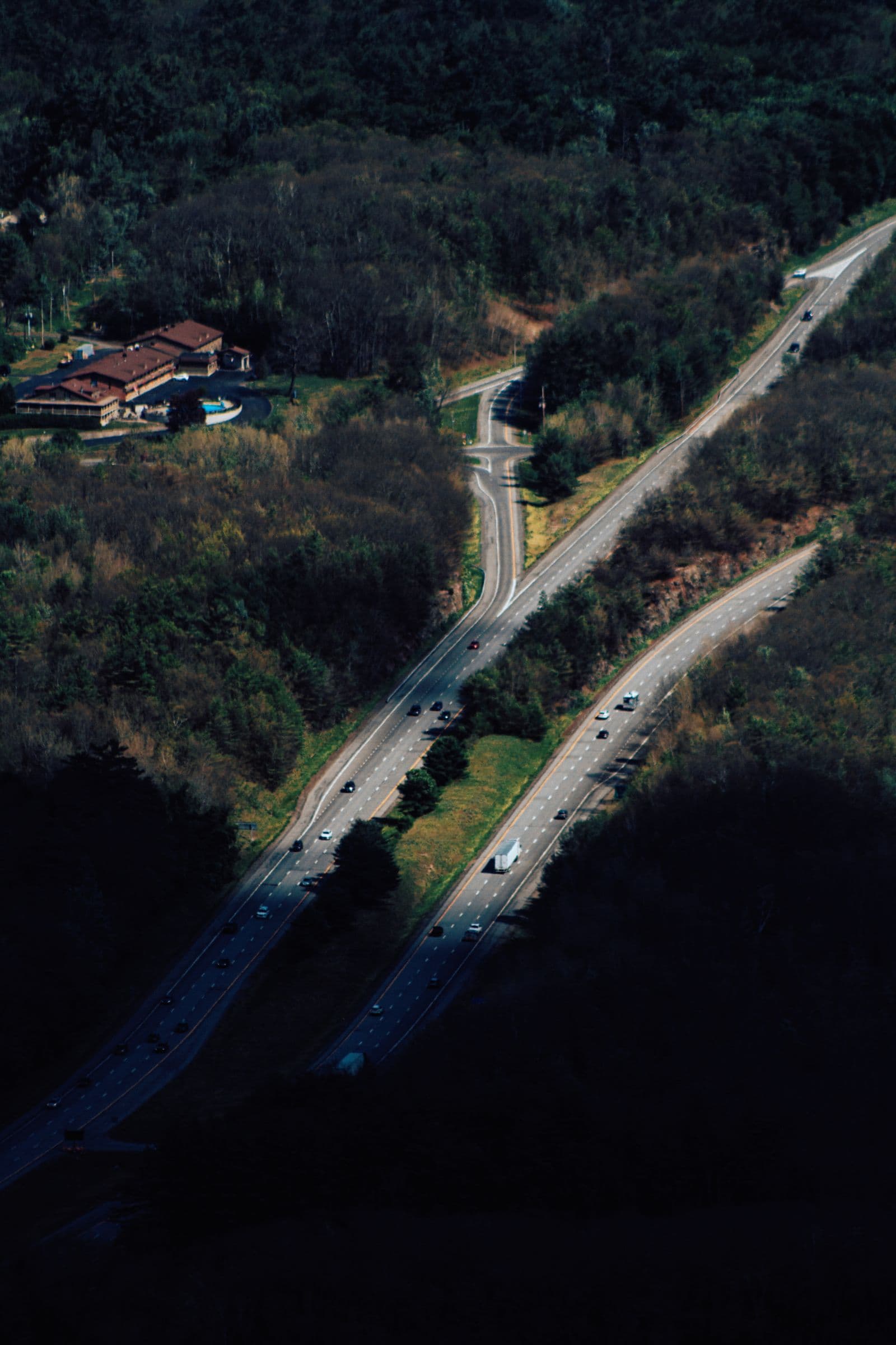 Car driving down an open highway toward the horizon
