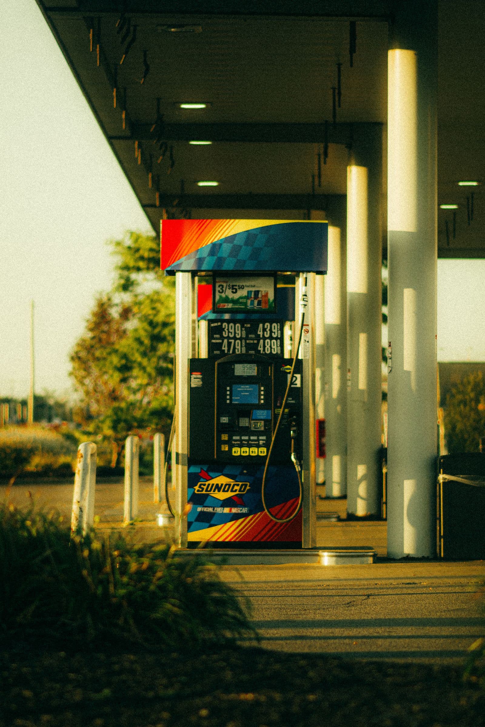 Illuminated gas station price sign at dusk