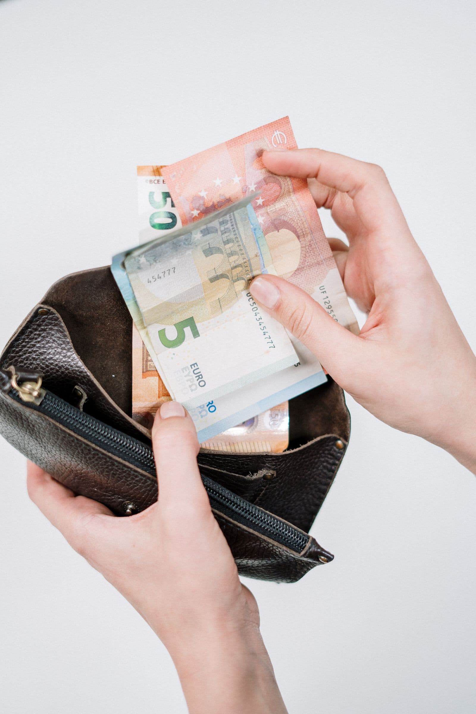 Person budgeting with cash and a calculator